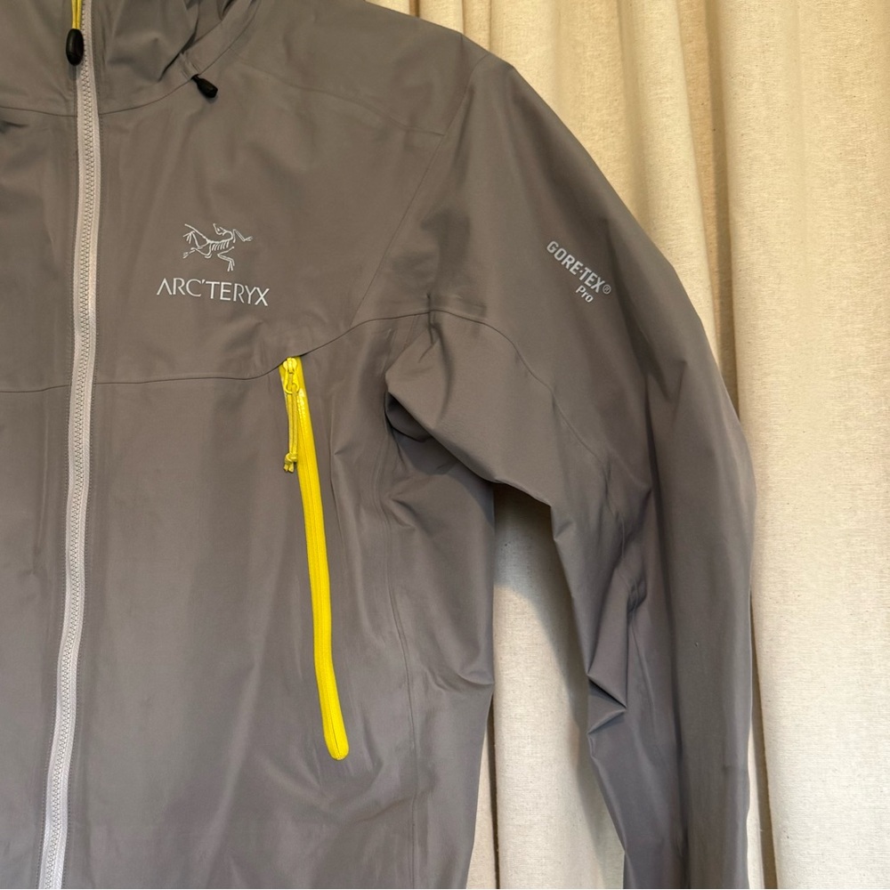 Arc'teryx Light Gray Ski Jacket with Yellow Accents